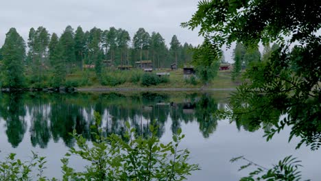 Panorama-of-glomma-river-in-early-summer-morning-reflations-of-the-trees-in-water-in-Norway