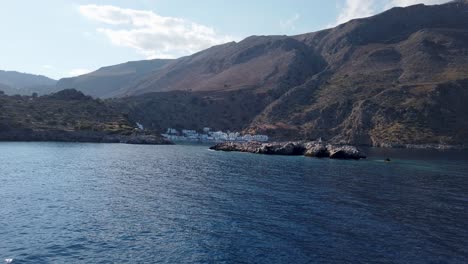 View-from-a-boat-of-the-arrival-at-the-stunning-and-isolated-village-of-Loutro-embedded-in-the-mountains