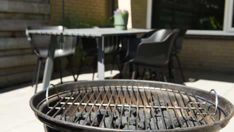 Slowmotion-zooming-in-shot-of-a-barbecue-BBQ-in-a-backyard