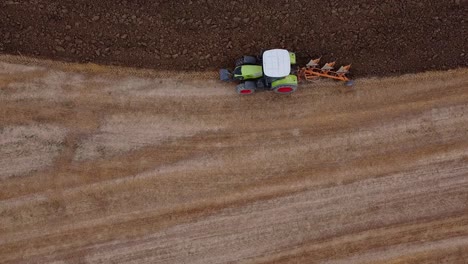Aerial-drone-monitoring-of-solo-farmer-tractor-ploughing-fields-Marche
