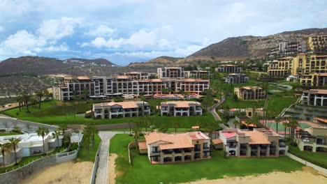 Aerial-drone-shot-of-hotel-and-villa-in-front-of-the-beach-in-Cabo-San-Lucas-Mexico