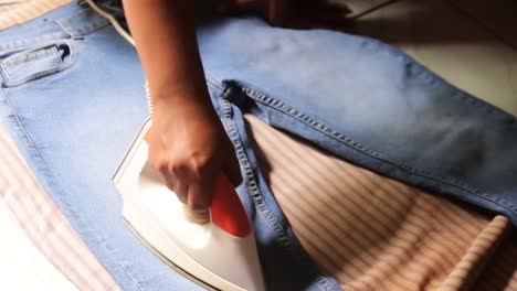 hand-ironing-jeans-laundry-business-concept