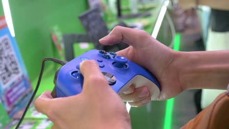 A-visitor-plays-a-videogame-using-a-controller