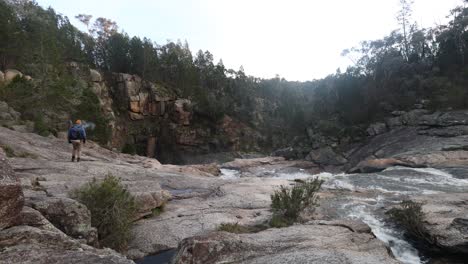 A-bushman-smoking-a-pipe-while-exploring-a-waterfall-in-the-Australian-bush