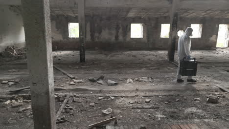 Forensic-scientist-walks-through-an-abandoned-hall-with