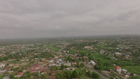 Wide-aerial-flyover-of-the-suburbs-of-a-city-in-rural-Sierra-Leone-during-the-day