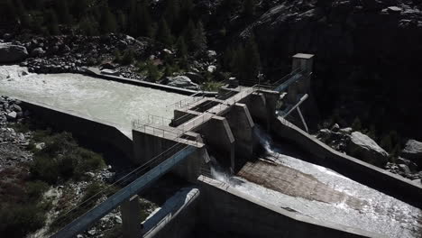 Concrete-installation-in-the-mountains:hydroelectric-dam-seen-by-drone-in-the-Swiss-alps