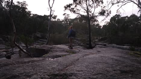 A-bushman-walking-in-the-early-morning-of-winter-accross-rocky-gorge-country-in-Australia
