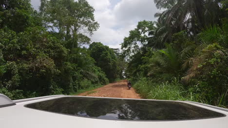 Hyperlapse-footage-on-top-of-a-car-that-is-going-through-villages-and-the-jungle-on-a-dirt-road