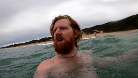 A-slow-motion-close-up-shot-of-a-man-in-the-ocean-swimming