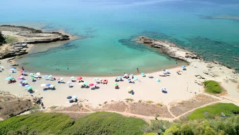 White-sand-beach-and-turquoise-blue-water-between-rocks-cove-on-the-island-of-Sardinia-Italy