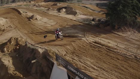 Skilled-motocross-rider-on-a-sandy-track-performing