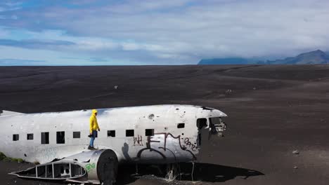 person-walking-on-a-plane-wreck-in-iceland