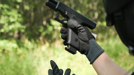 Army-guy-reloading-pistol-magazine-with-gloves