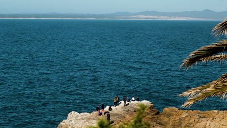Spectators-whale-watching-from-rocky-shoreline-in-Hermanus