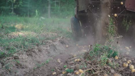 Potato-harvesting-by-old-digger-slow-motion-dirt