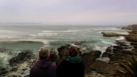 Couple-on-cliffside-lookout-point-doing-whale-watching