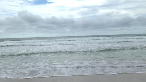 Panning-of-a-paradise-beach-on-a-cloudy