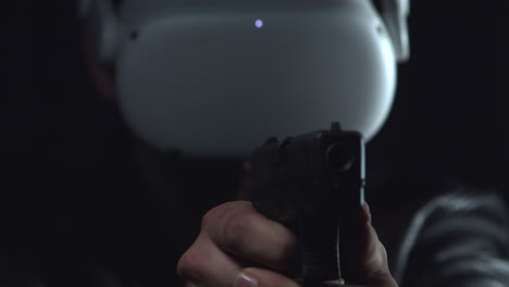 Person-wearing-virtual-reality-goggles-points-a-gun