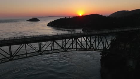 Aerial-shot-of-an-empty-Deception-Pass-bridge-during-a-warm-summer-sunset