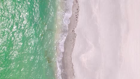 Aerial-top-view-of-ocean-blue-waves-break