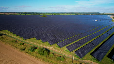 Aerial-flyover-large-Modern-power-station-farm-with-solar-panels-during-sunny-day-in-Poland