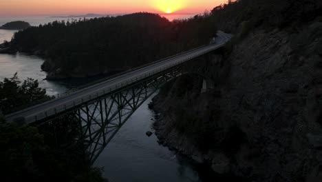 Aerial-shot-flying-over-the-shorter-side-of-the-Deception-Pass-bridge-at-sunset