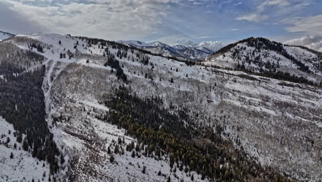 Park-City-Utah-Aerial-v54-breathtaking-winter-landscape,-drone-flyover-mountain-slopes-capturing-white-pine-canyon-mountainscape-covered-in-snow-on-a-sunny-day---Shot-with-Mavic-3-Cine---February-2022