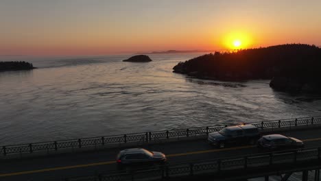 Long-aerial-shot-starting-of-the-sunset-over-the-San-Juan-Islands-and-pulling-back-to-reveal-the-Deception-Pass-Bridge
