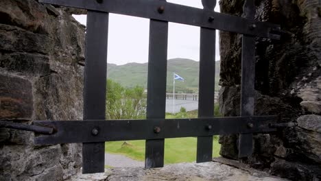 Scotland-national-flag-behind-window-bars-of-medieval