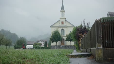 Church-slow-zoom-trees-rain-path-fog-cloudy