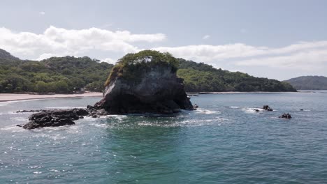 Fast-Aerial-Circling-Timelapse-Of-A-Small-Rock-Formation-Off-The-Coast-Of-Costa-Rica