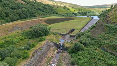 Aerial-drone-video-footage-of-a-reservoir-dam-wall-showing-overflow-structures