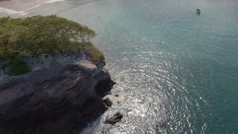 Aerial-Revealing-Shot-Panning-From-The-Sea-Up-Towards-The-Coastal-View-Of-The-Stunning-Beach-Of-Playa-Real,-Guanacaste-Province
