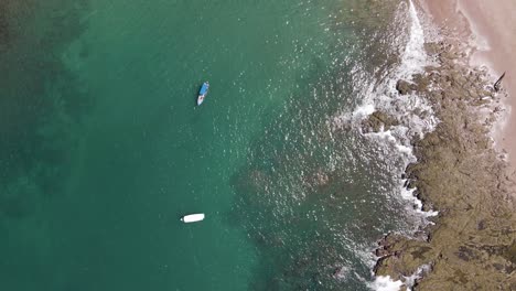 Luftaufnahme-Von-Oben-Nach-Unten-Von-Zwei-Fischerbooten,-Die-Mit-Der-Flut-An-Der-Küste-Von-Costa-Rica-Schwimmen