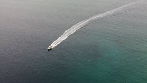 Aerial-follow-shot-of-a-high-speed-boat-returning-to-Milna-Port-after-a-fishing-session-over-the-Adriatic-Sea,-Brac-Island,-Croatia