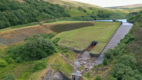 Aerial-video-footage-of-a-reservoir-dam-wall-showing-overflow-structures