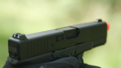 Army-guy-pistol-slide-locks-and-reloading-pistol-magazine