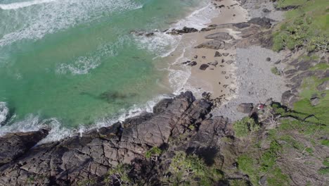 Foamy-Ocean-Waves-Hitting-Rocky-Coast-Of-Cabarita-Beach-In-New-South-Wales,-Australia---aerial-drone-shot