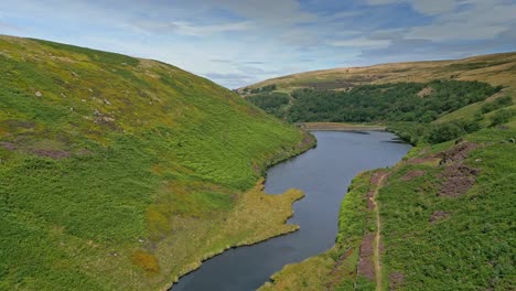 Aerial-footage-of-Yorkshire-countryside-with-valleys-moorland-and-reservoir-lake,-water-1