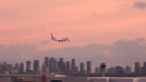 An-XXX-aircraftflies-descends-across-the-city-skyline-before-landing-on-a-runway-at-Pearson-International