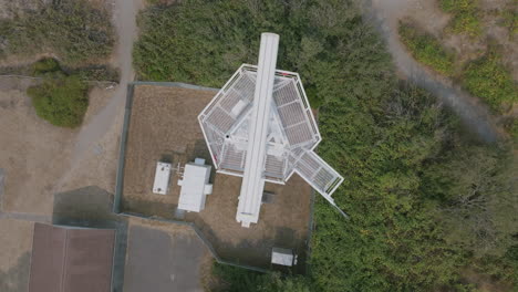 Aerial-top-down-footage-of-a-radar-tower-with-the-radar-beam-spinning-around