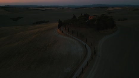 Val-d'Orcia-and-Pienza-sunset-aerial,-famous-nature-valley-and-medieval-Tuscany-town-near-iconic-Siena-and-Florence,-Italy,-close-to-Chianti-wine-and-vinery-area,-seen-from-above