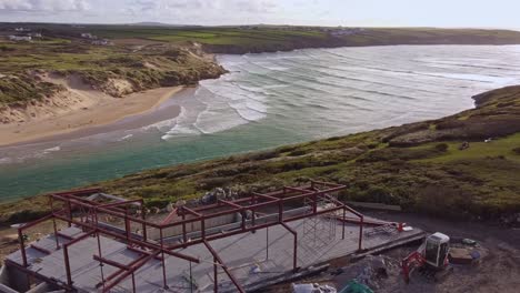 Aerial-shot-steel-frame-construction-overlooking-seaside-in-Cornwall-2