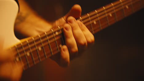 Primer-Plano-De-Los-Dedos-Tocando-La-Guitarra-Eléctrica-1