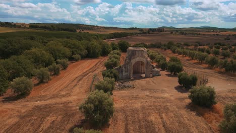 Old-medieval-church-monastery-abbey-Abbazia-di-San-Bruzio,-a-damaged-abandoned-ruin-in-Tuscany-from-the-11th-century-Middle-Ages-surrounded-by-olive-trees-in-Italy