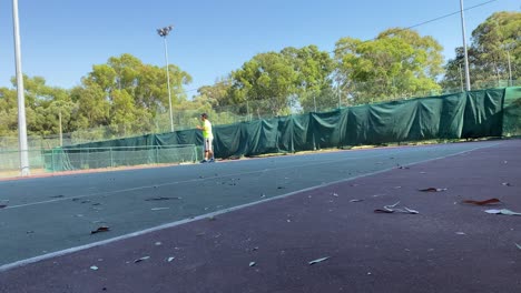 Man-hitting-yellow-tennis-ball-with-the-racket
