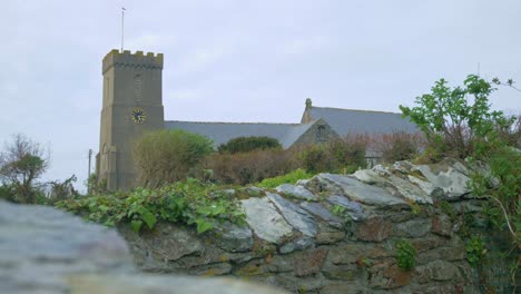 Church-spire-steeple-tower-background-of-green-village-in-Cornwall-close-up