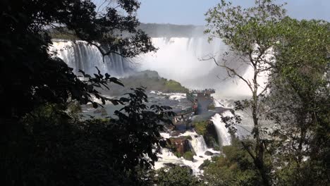 Tourists-on-platform-above-Iguacu-river,-at-Iguacu-Falls,-Brazil-Argentina-border