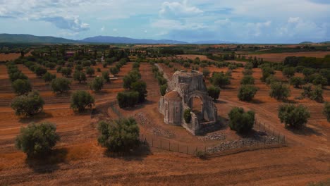 Old-medieval-church-monastery-abbey-Abbazia-di-San-Bruzio,-a-damaged-abandoned-ruin-in-Tuscany-from-the-11th-century-Middle-Ages-surrounded-by-olive-trees-in-Italy-1